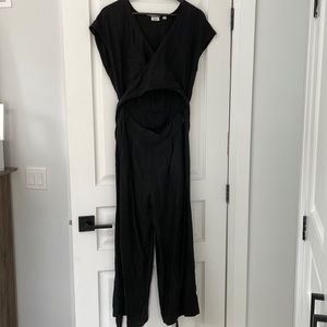 WILFRED Brax wide leg jumpsuit in black with wrap top and mid drift cut out.